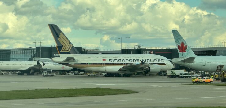 a group of airplanes parked at an airport