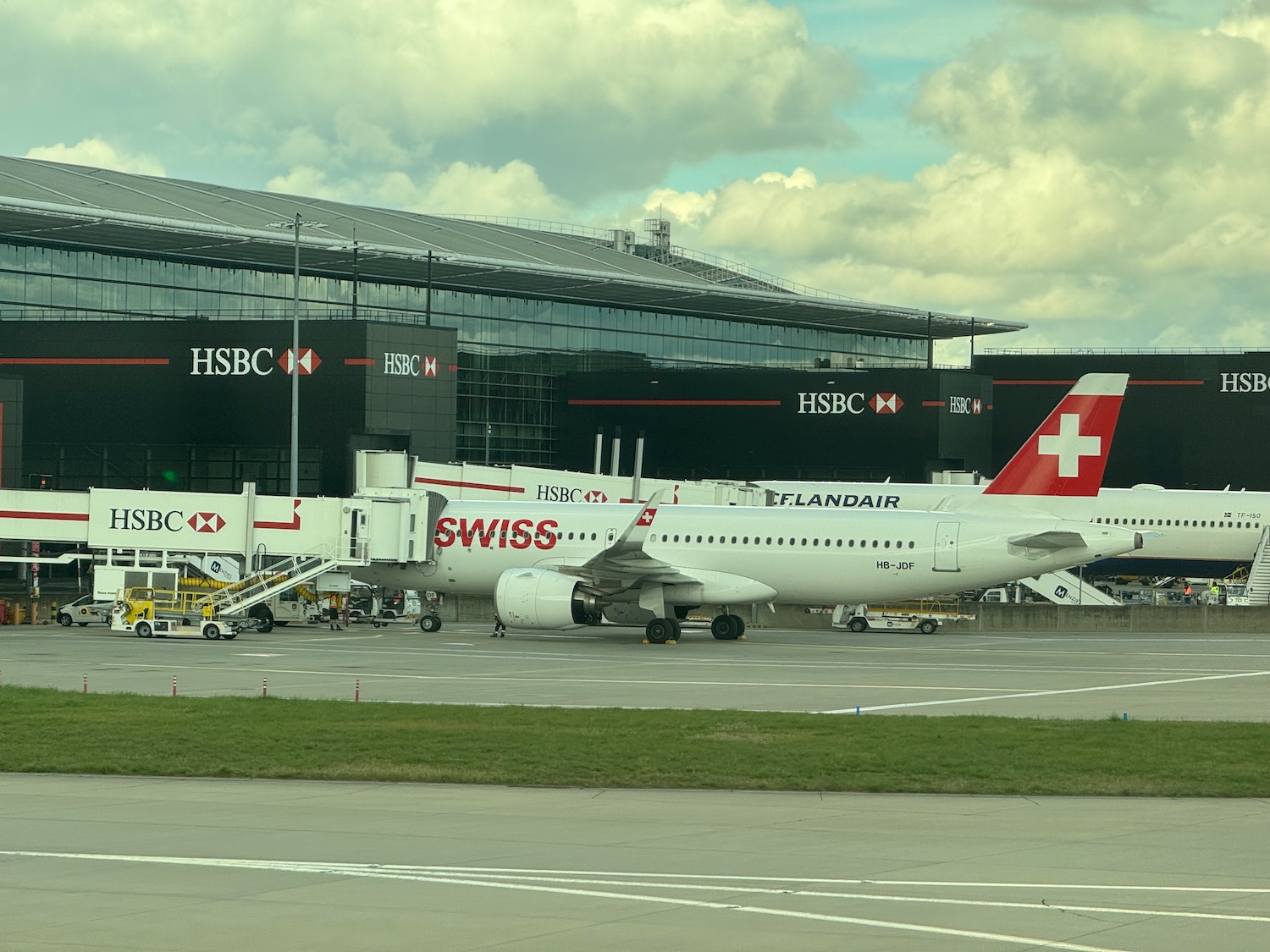 a large white airplane parked in front of a building