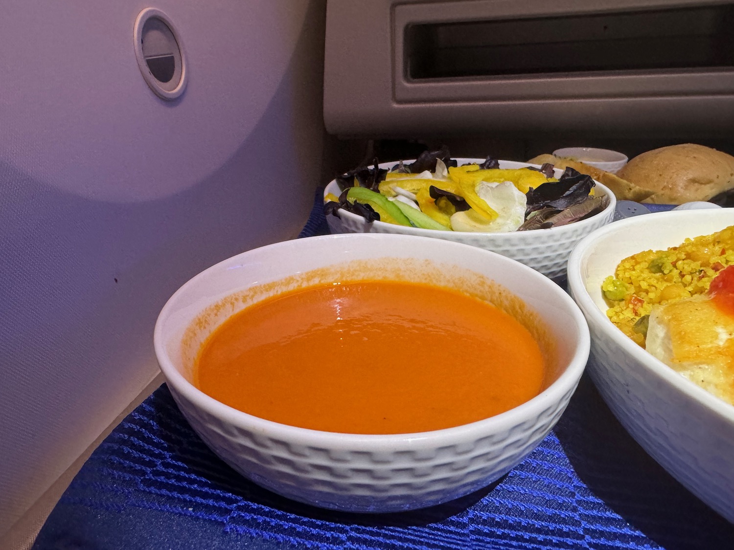 a bowl of soup and a bowl of food on a table