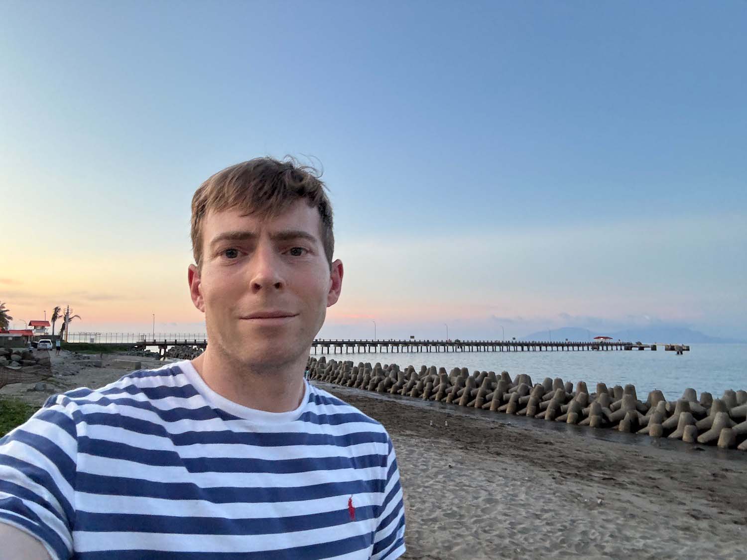 a man taking a selfie on a beach