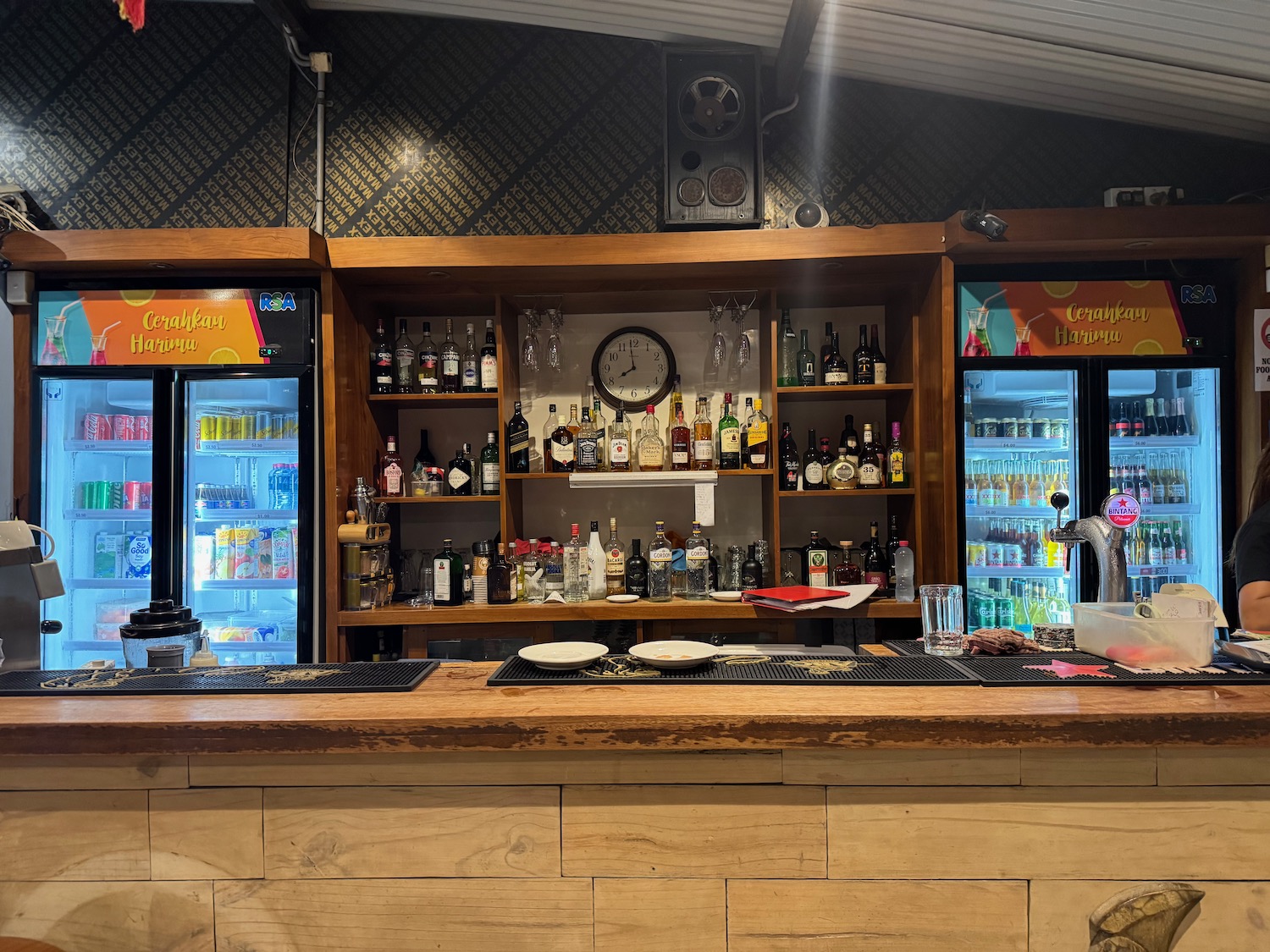 a bar with bottles and glasses on it