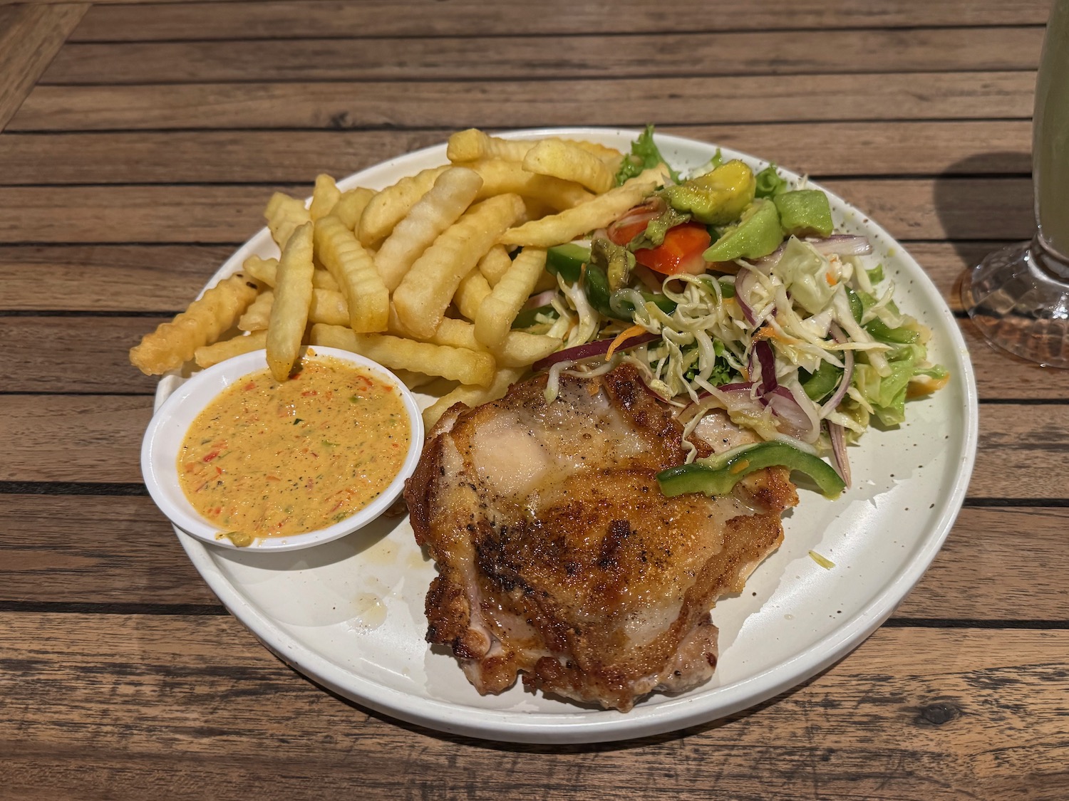 a plate of food with a side of salad and french fries