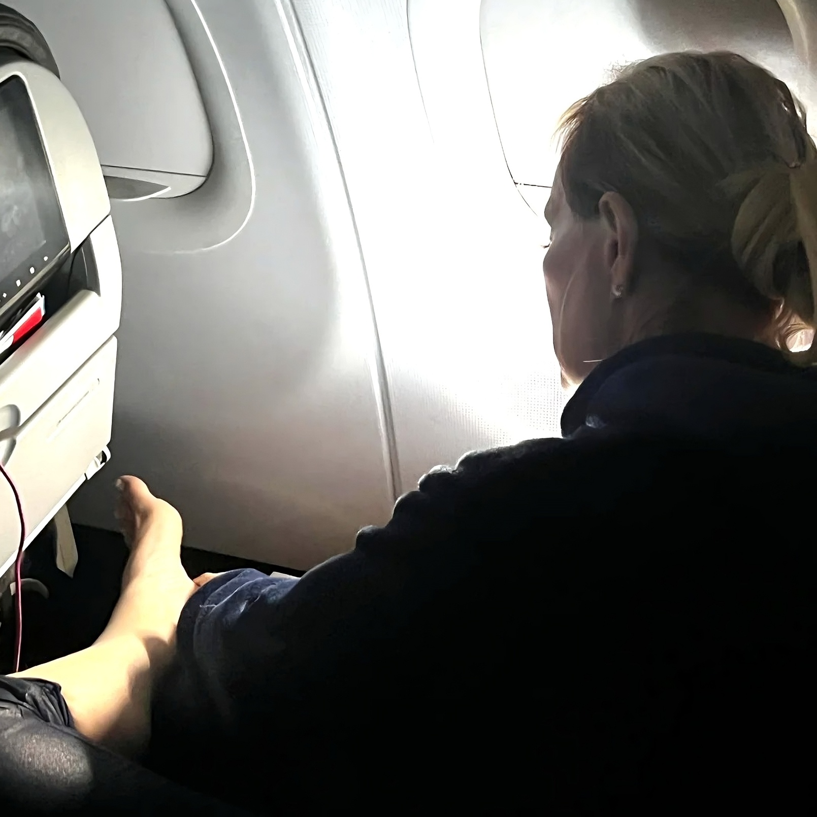 a woman sitting in an airplane