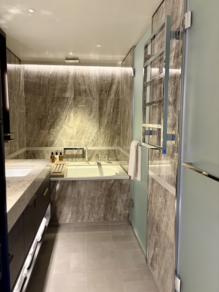 a bathroom with marble walls and a bathtub