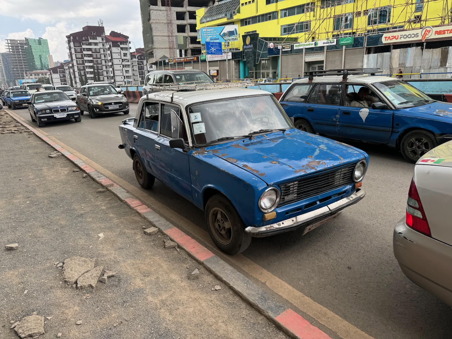 a blue car on a street