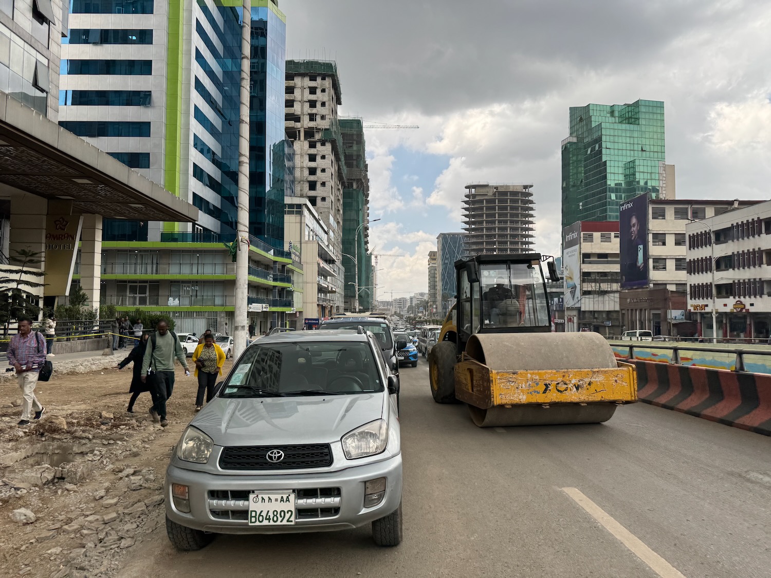 a road with a construction vehicle and a bulldozer