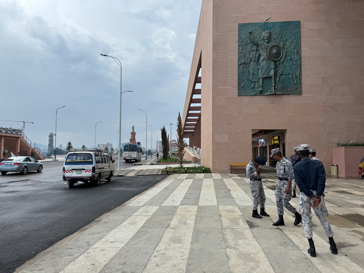 a group of people in uniform walking on a sidewalk