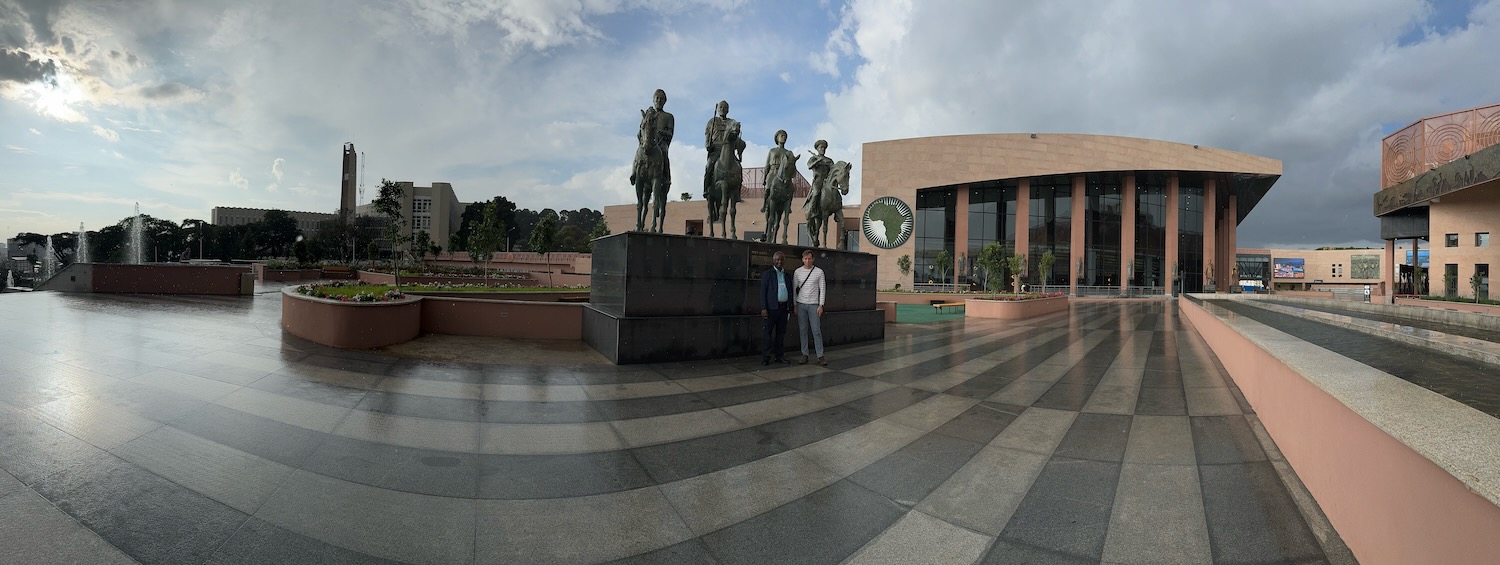 a group of people standing in front of a statue