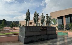 a statue of men on horses in front of a building