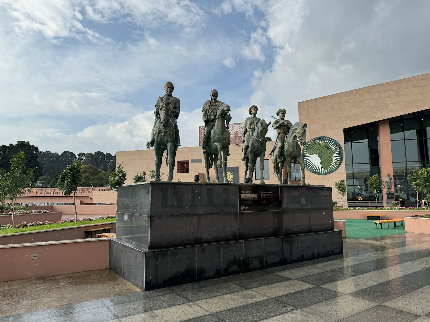 a statue of men on horses in front of a building