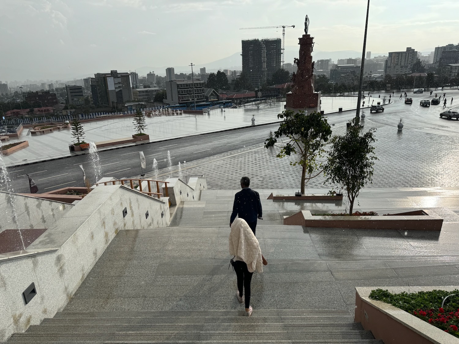 a man and woman walking up stairs in a city