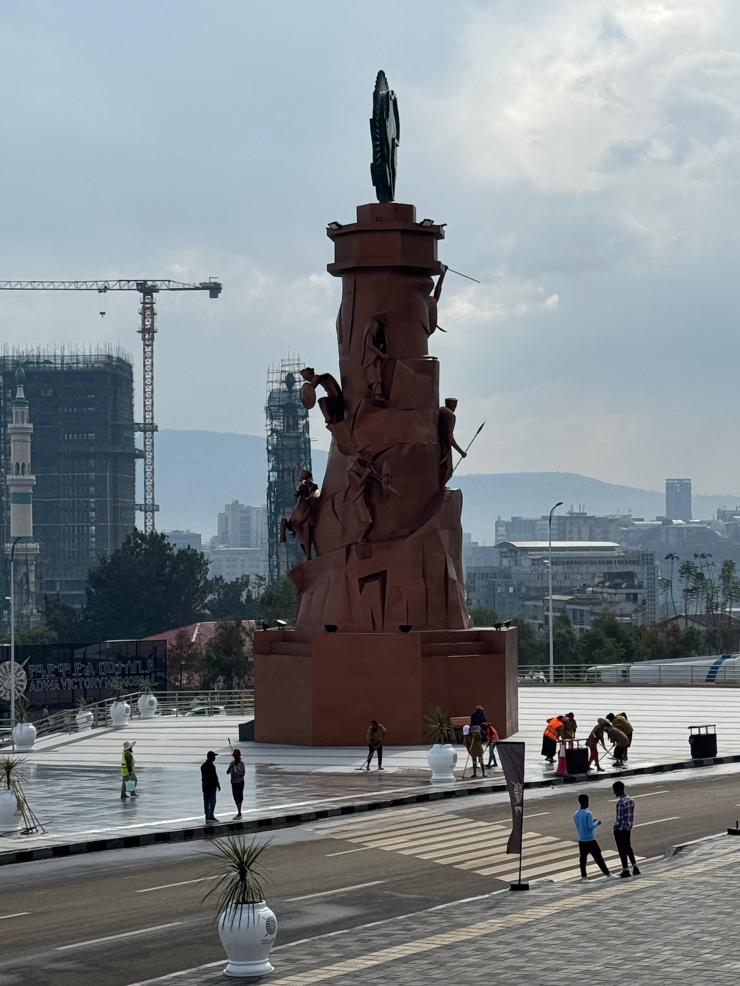 a statue of a man with a man standing on top of a tower