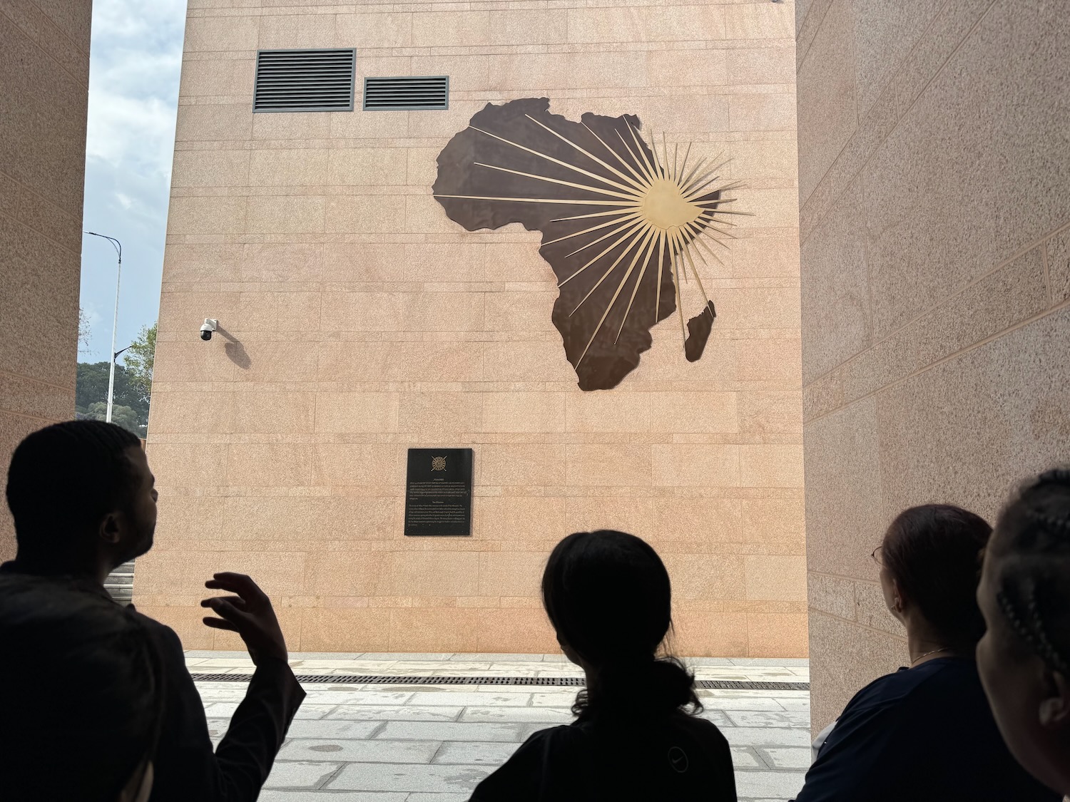 a group of people looking at a sign on a building