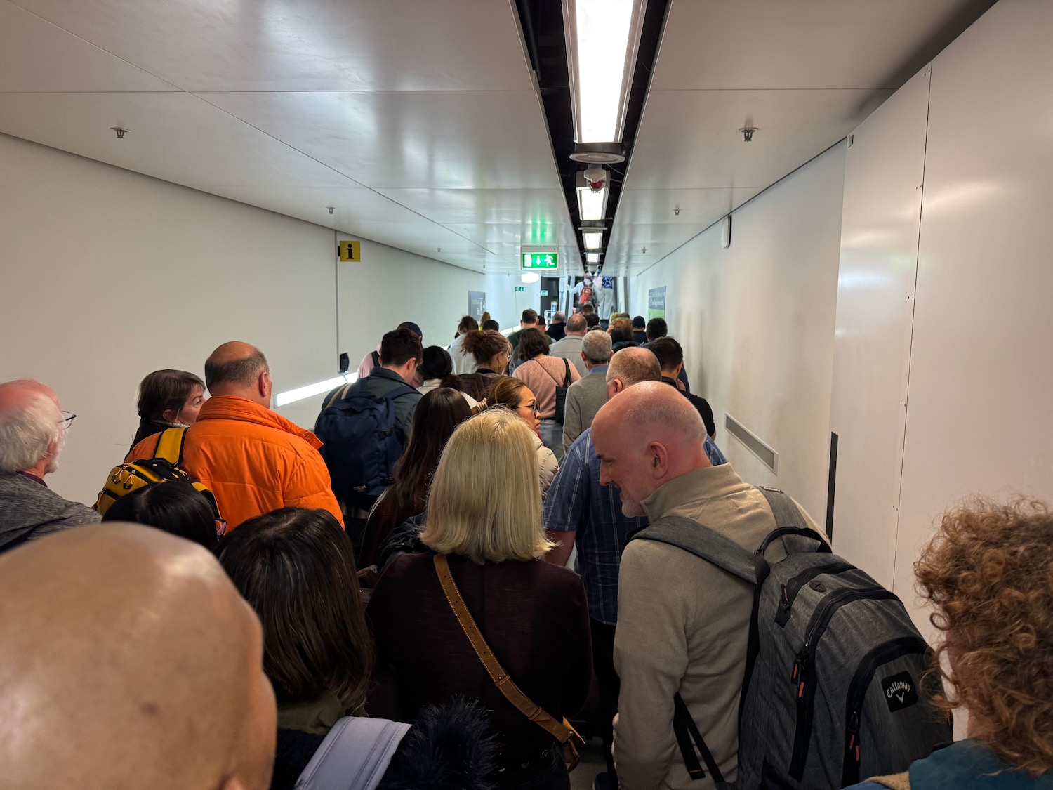 a group of people walking in a hallway