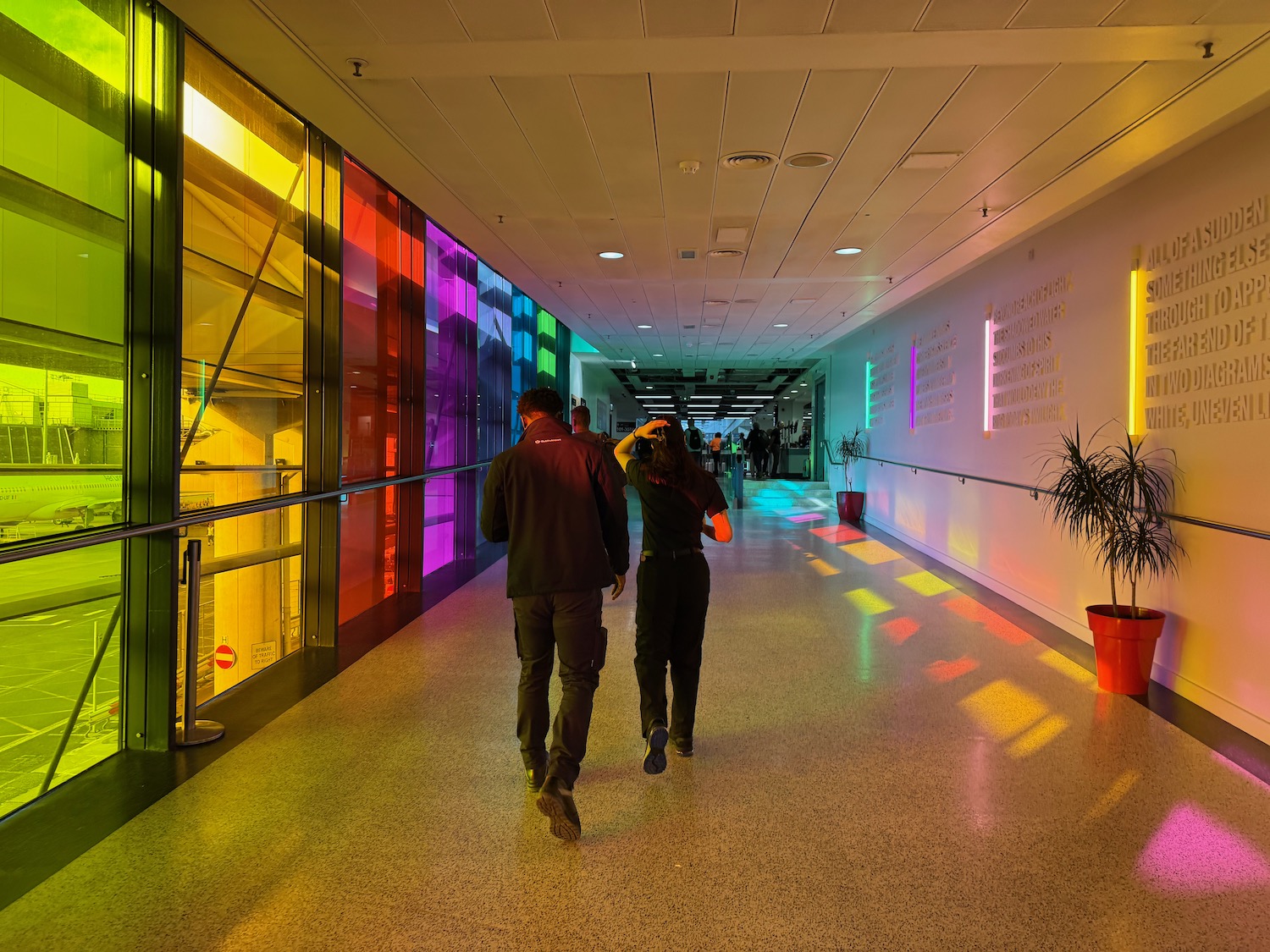 a man and woman walking in a hallway