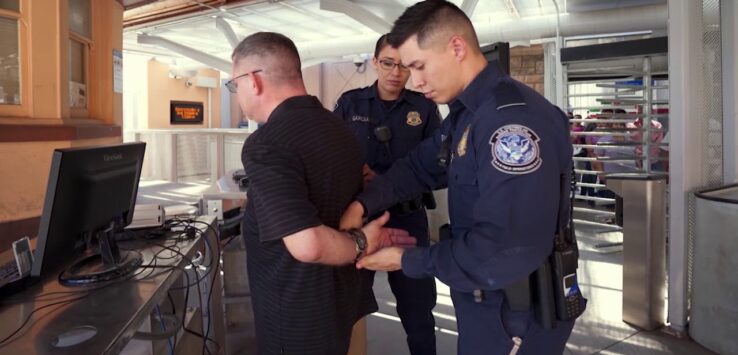 a police officer holding a handcuff