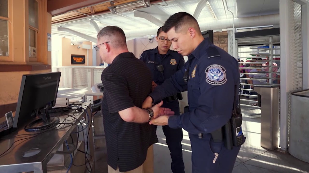 a police officer holding a handcuff