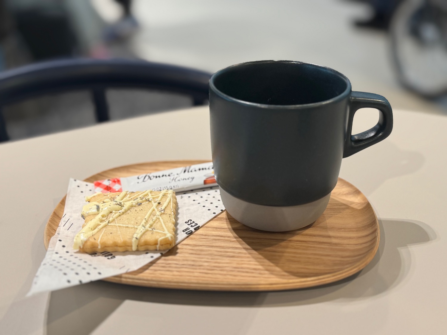 a coffee cup and a cracker on a tray