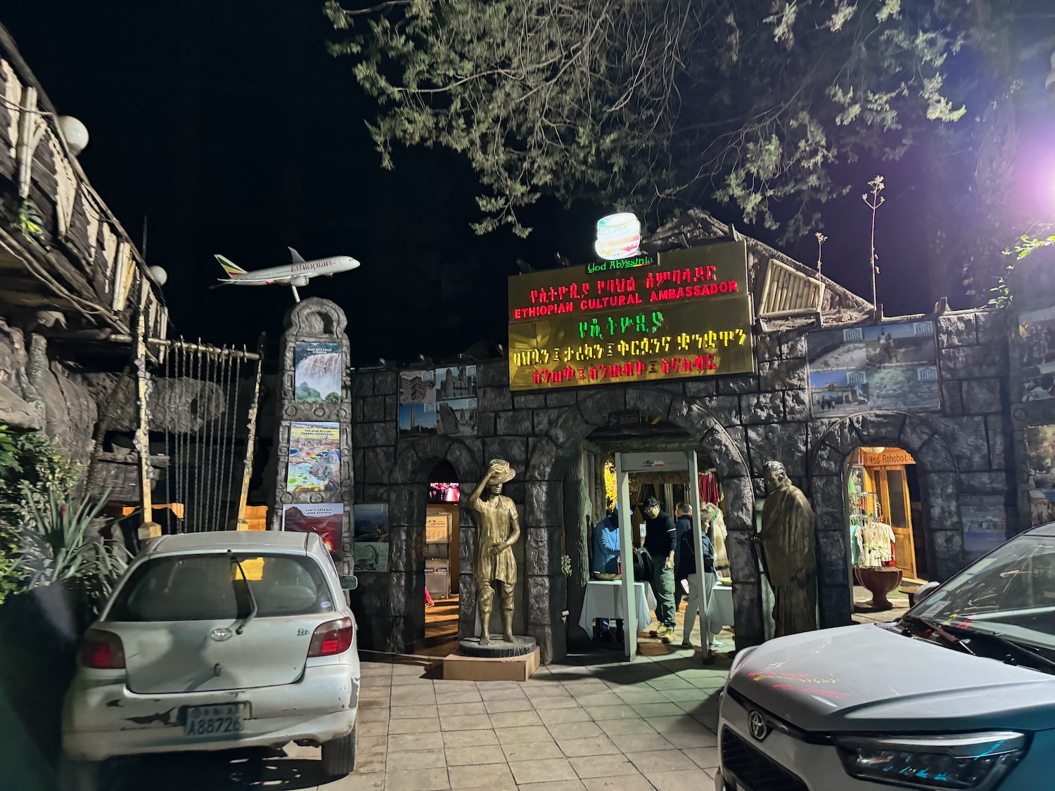 a building with a sign and a statue in front of it