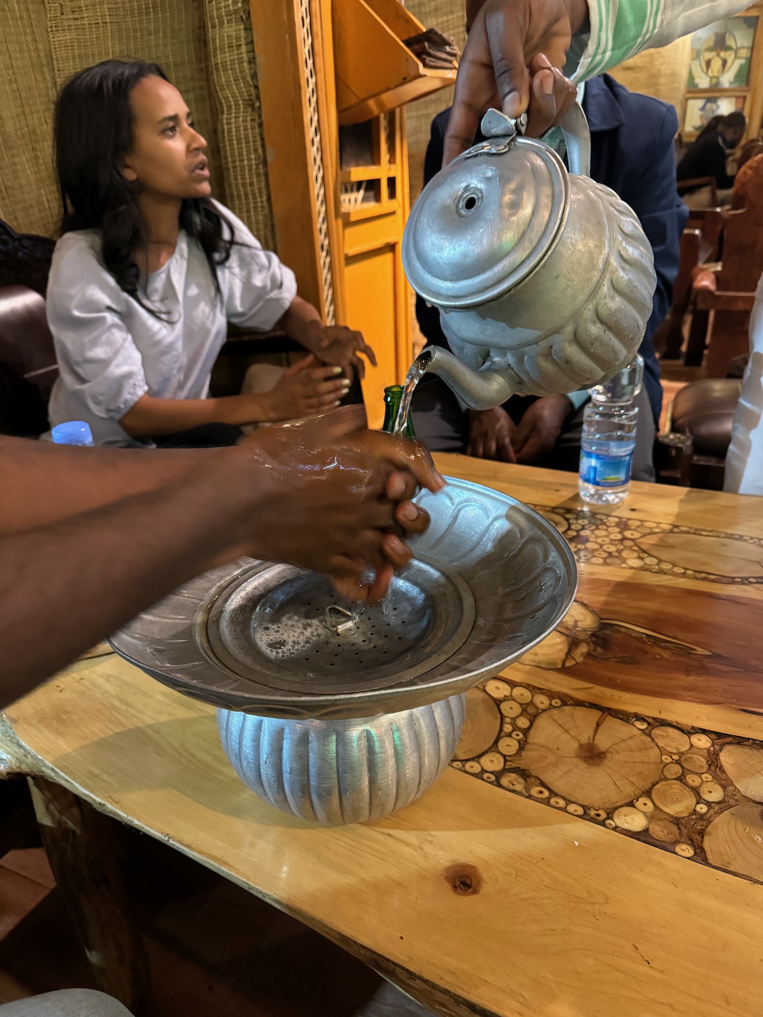 a person pouring water into a bowl