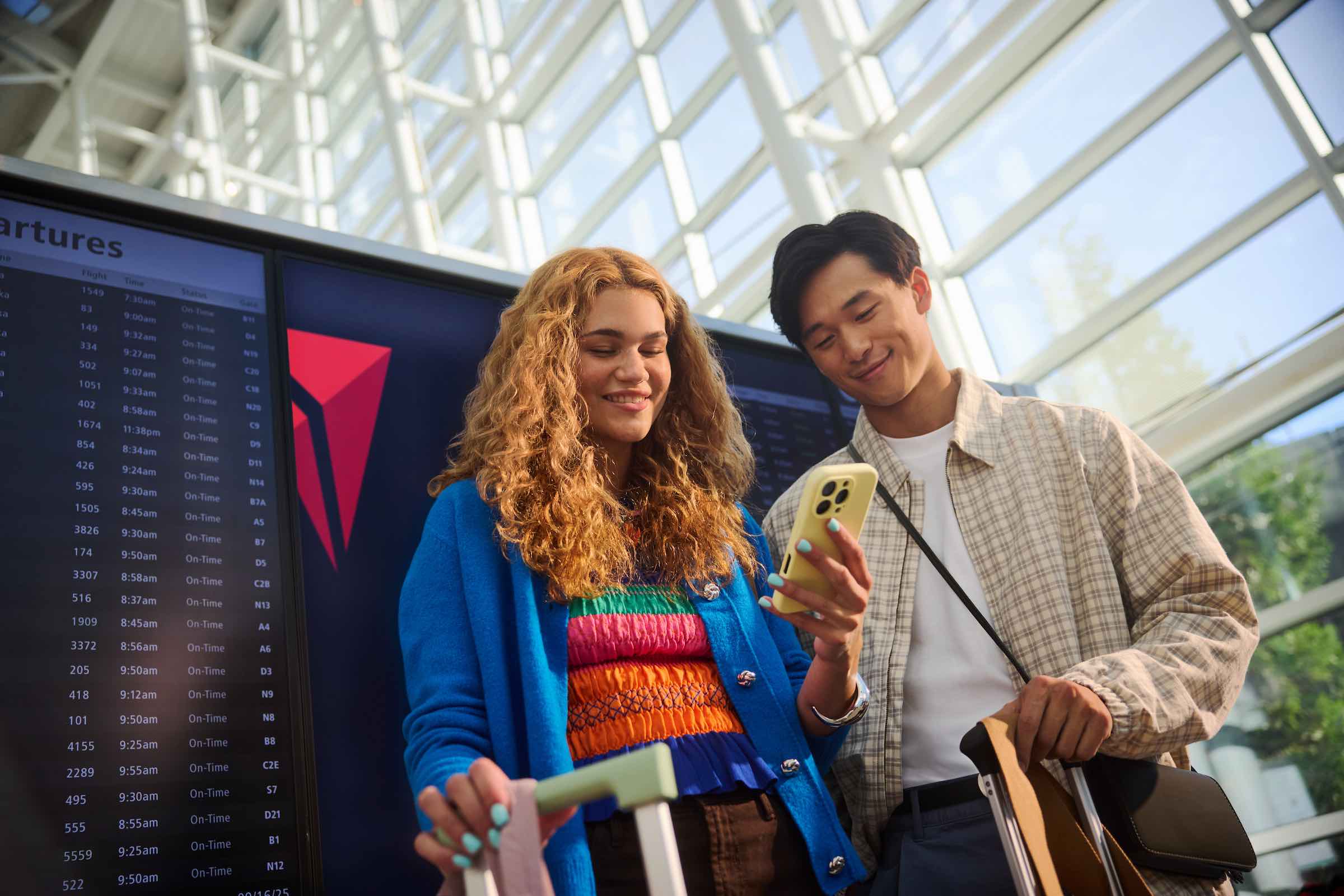 a man and woman looking at a phone