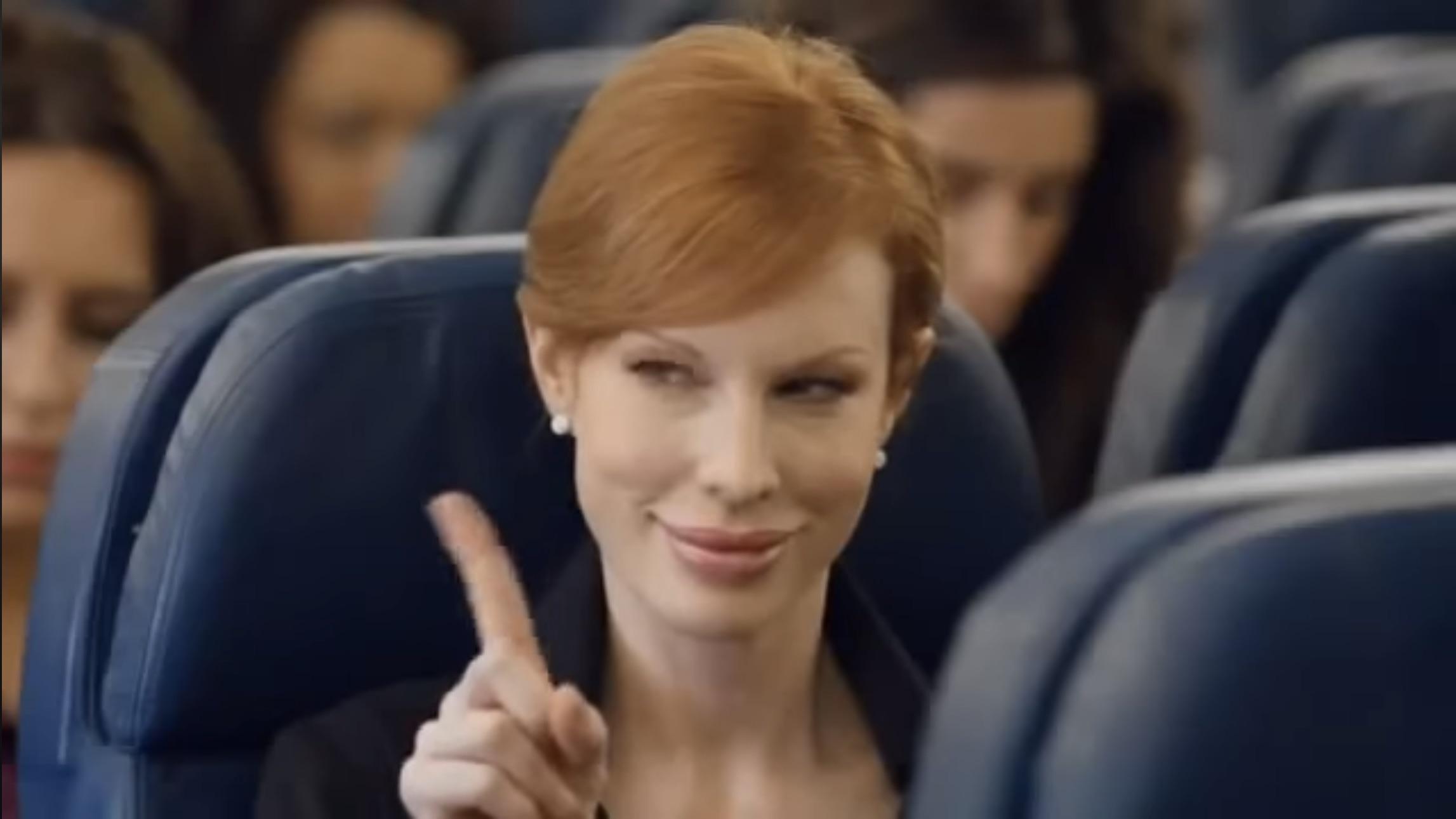 a woman sitting in a chair pointing up