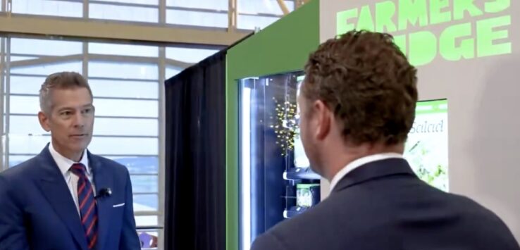 a man in a suit looking at another man