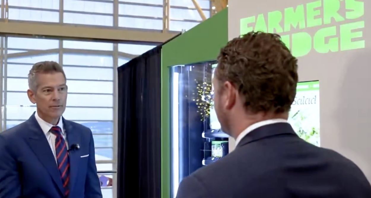 a man in a suit looking at another man