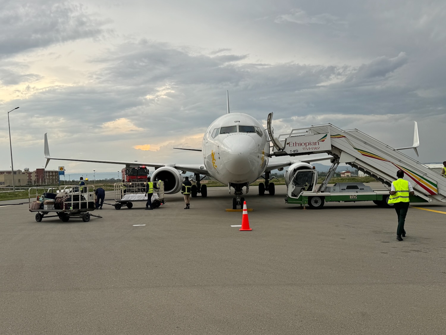 a plane with stairs and people around it