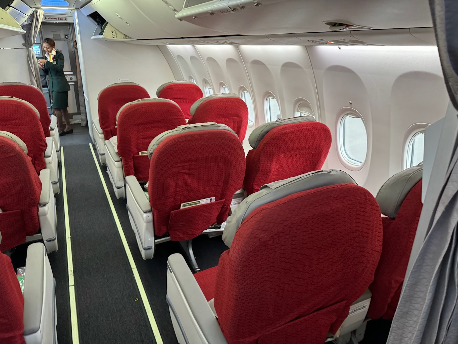 a row of red seats on an airplane
