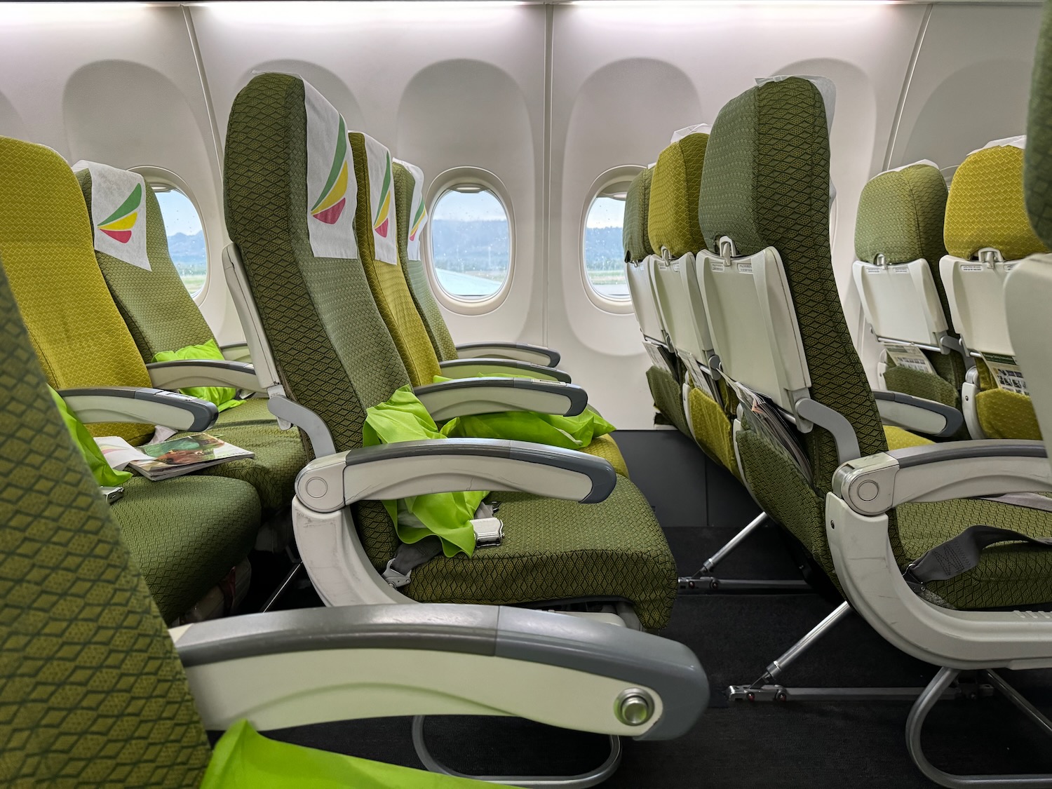 a row of green seats in an airplane