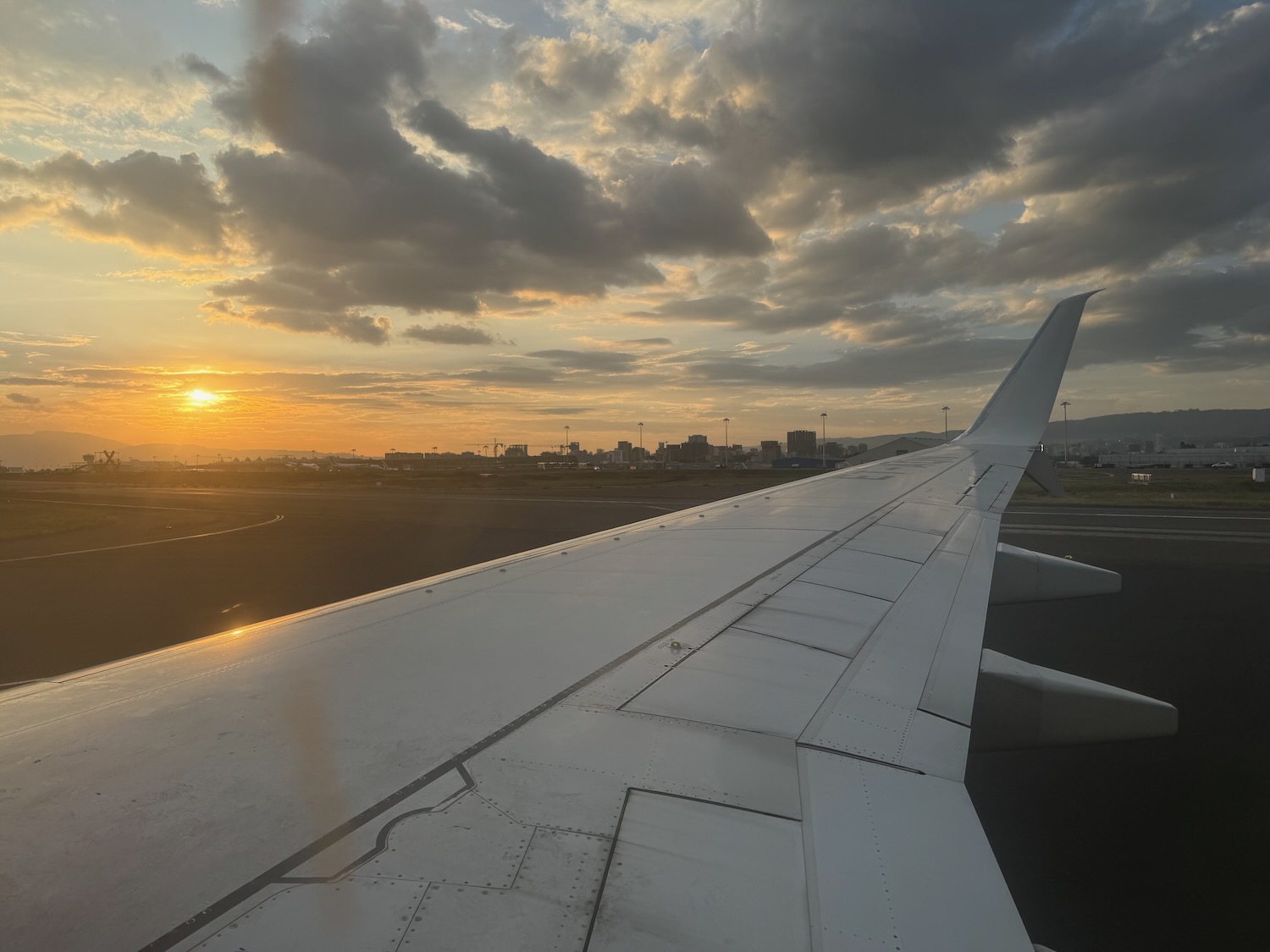 an airplane wing and a sunset