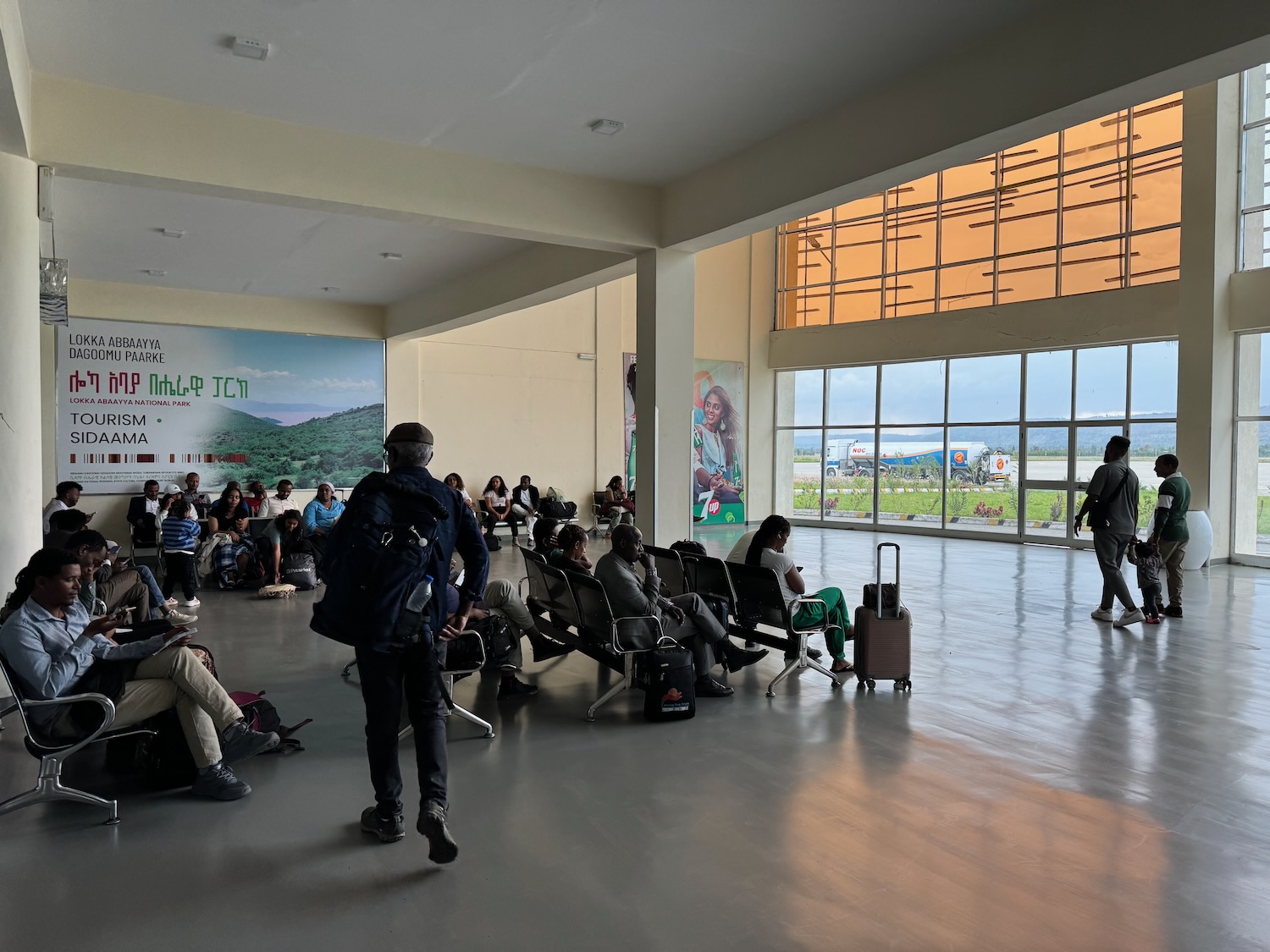 a group of people in a large room with large windows