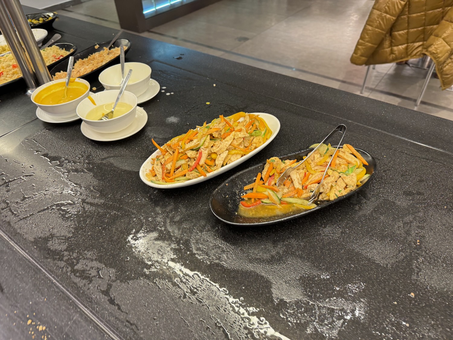 a row of plates of food on a counter