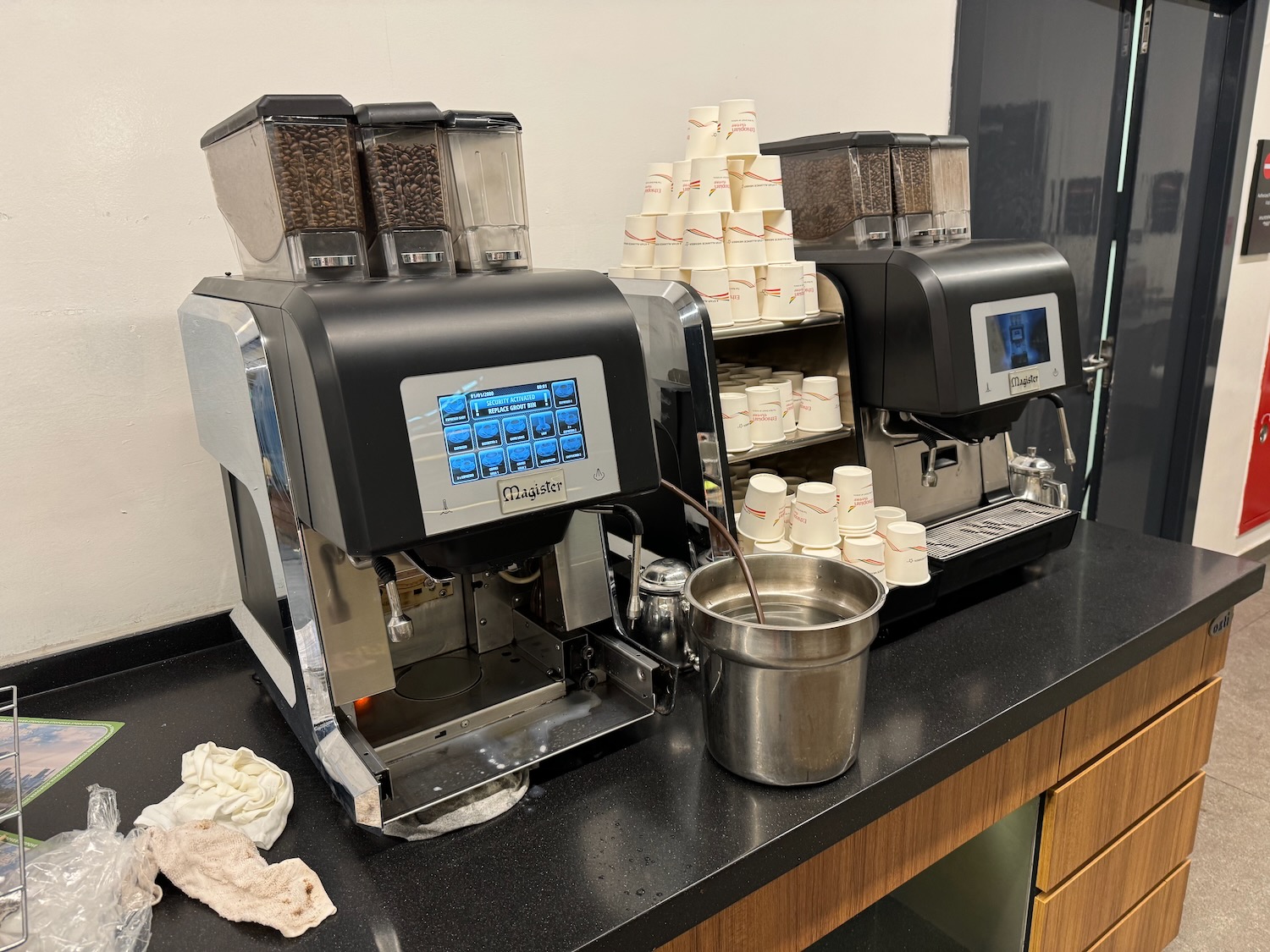 a coffee machine with cups on a counter