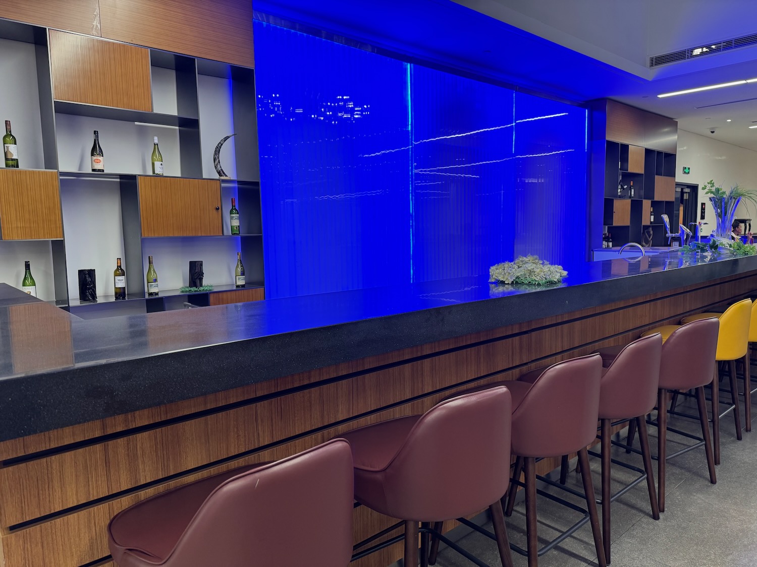 a bar with chairs and a blue wall