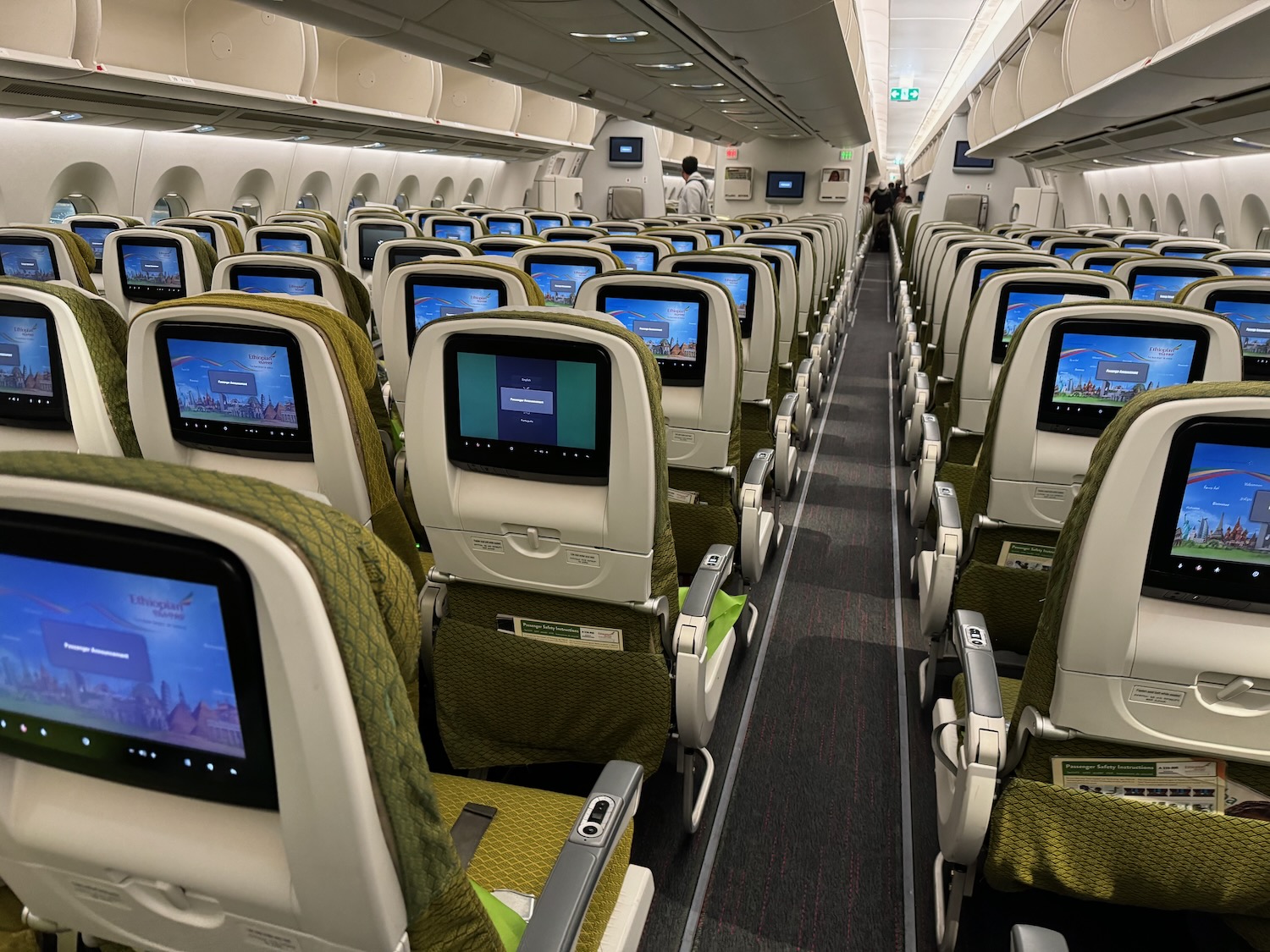 a row of seats with monitors on them