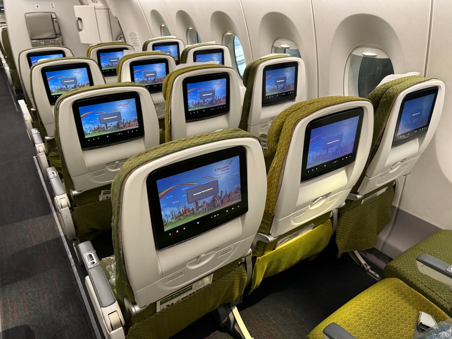 a row of seats with monitors on them
