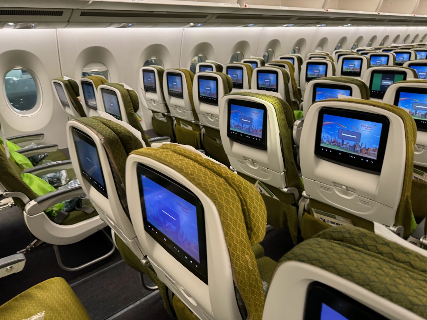 rows of seats with monitors on them