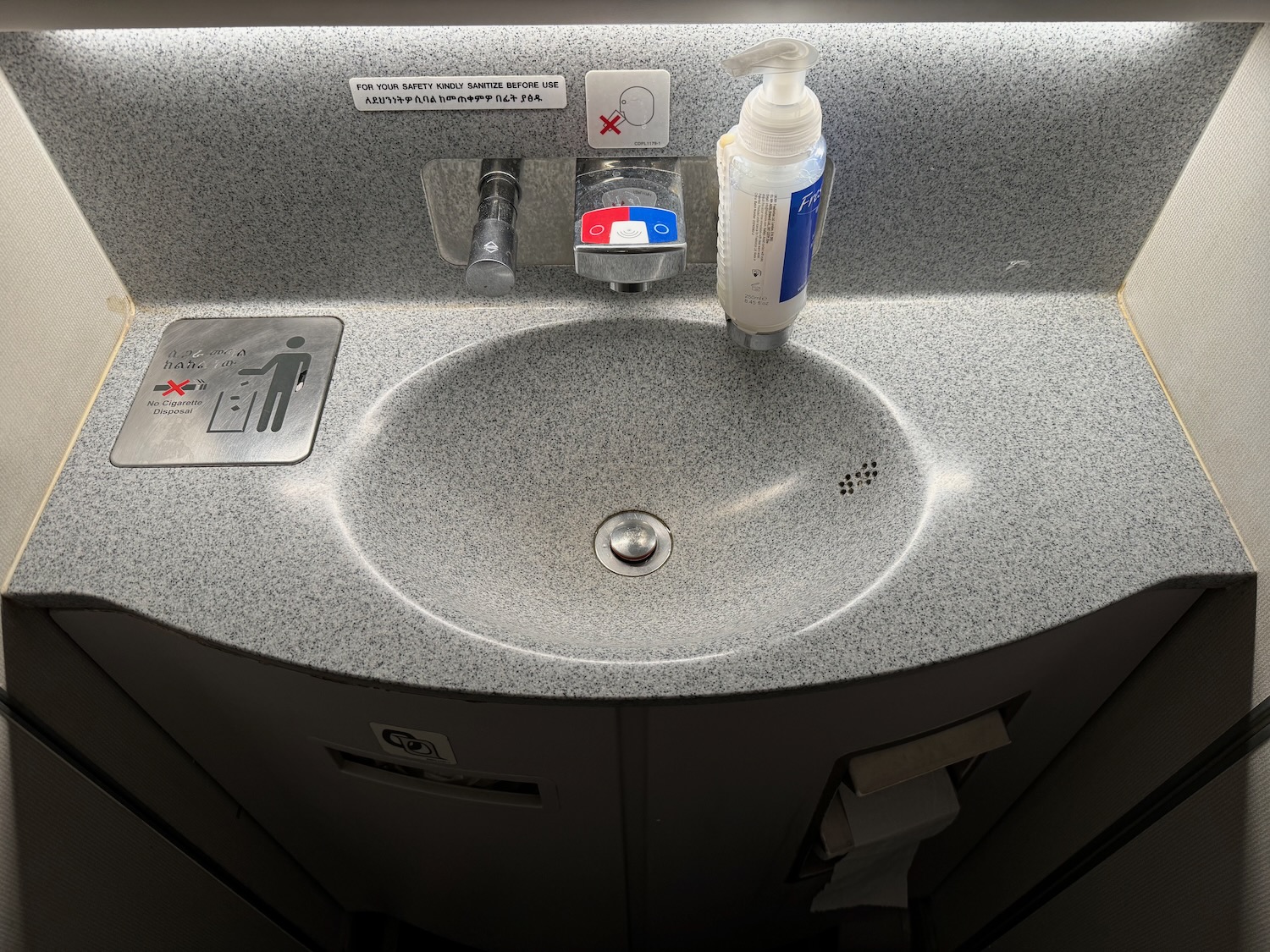 a sink with a bottle of soap and a bottle of liquid