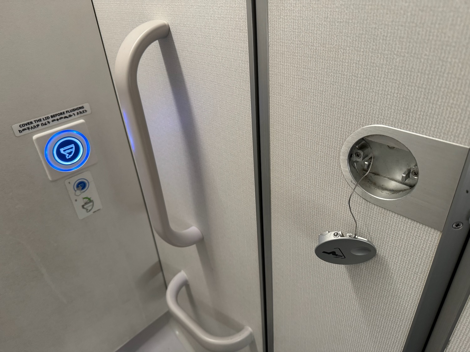 a door with a handle and a hole in the wall