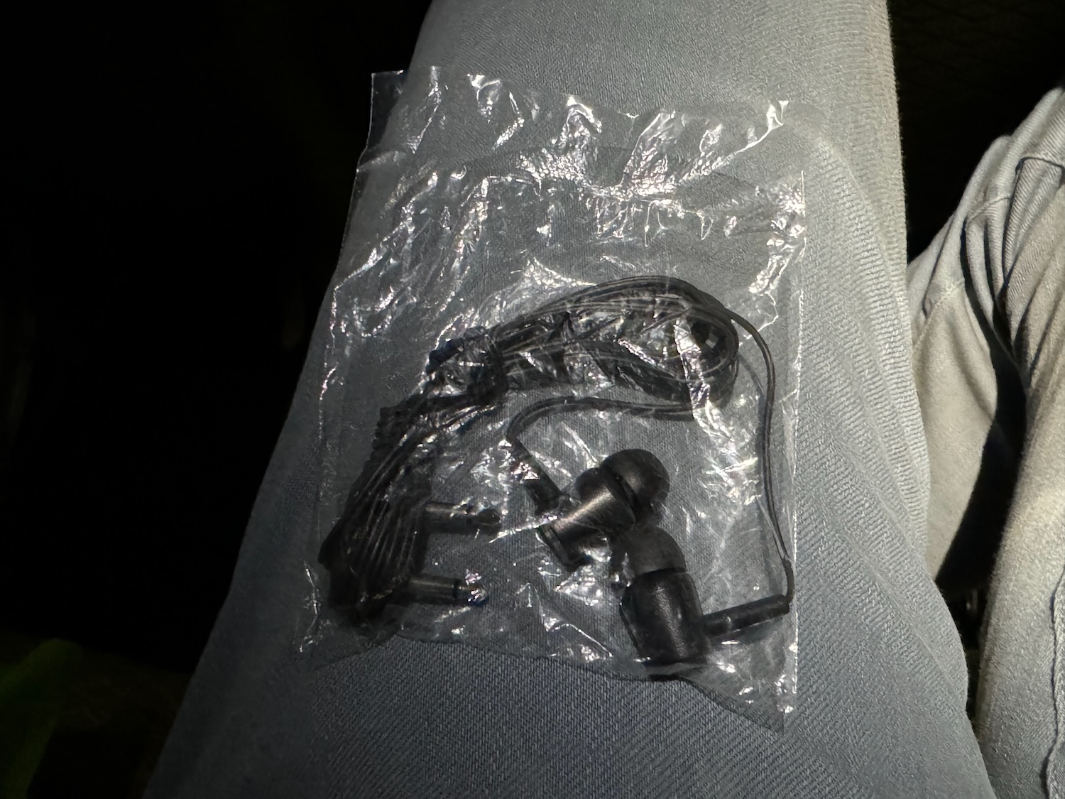 a pair of earbuds in a plastic bag
