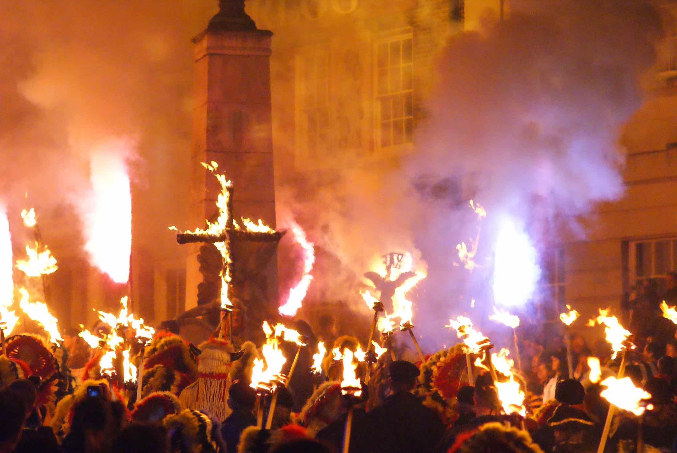 a group of people holding torches and fire