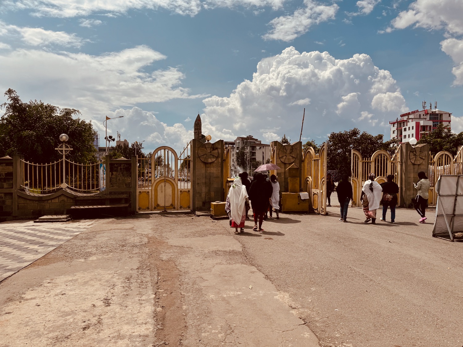 a group of people walking in a gated area