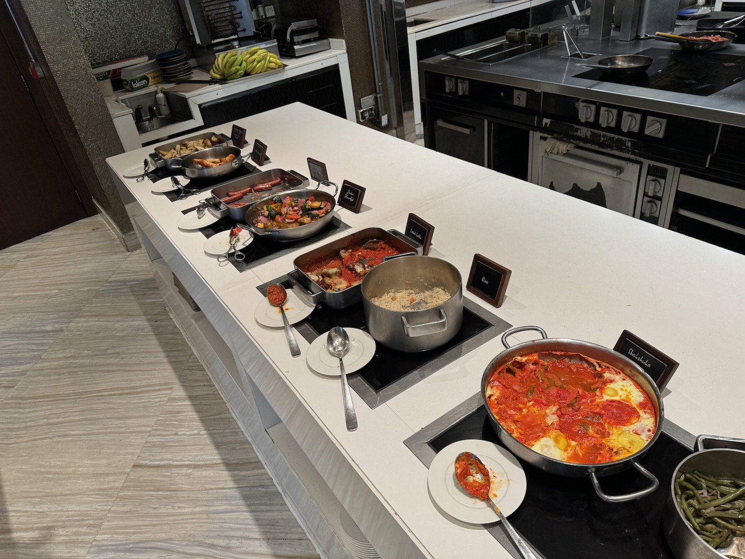 a large kitchen with many pots of food