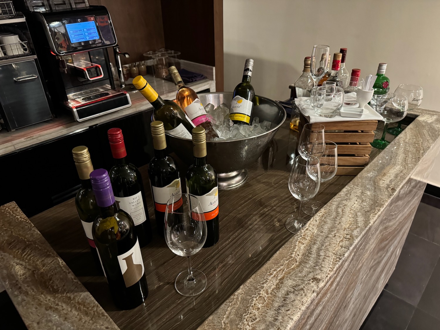 a group of bottles of wine in a bowl of ice on a counter