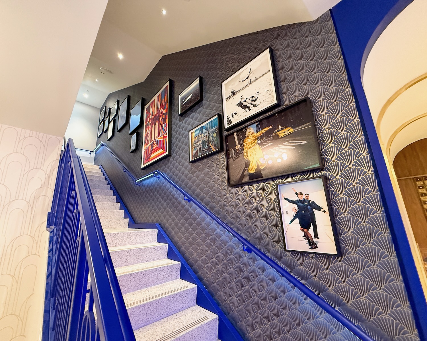 a staircase with pictures on the wall