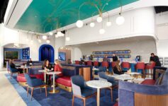 a group of people sitting at tables in a restaurant