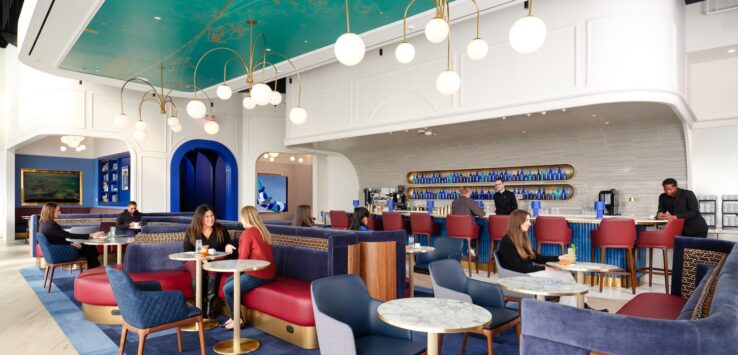 a group of people sitting at tables in a restaurant