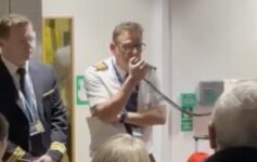 a man holding a microphone in front of a group of people